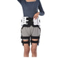 Hip fixation brace set with two white rigid shells and black straps, worn on both legs