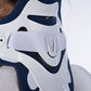 Close-up of white and navy plastic brace shell with molded openings and straps