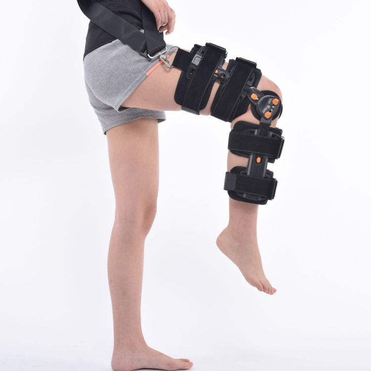 Black adjustable knee brace with several wide straps and hinged joint at the knee