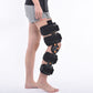 Adjustable black knee brace with multiple straps and circular hinge at the knee