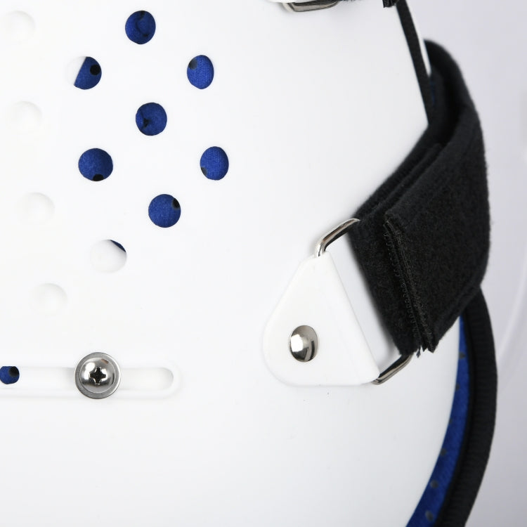 Close-up of thoracolumbar brace fastener: silver grommet on white panel with blue dots