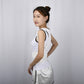 White posture correction belt with chest panel and padded shoulder straps, side view