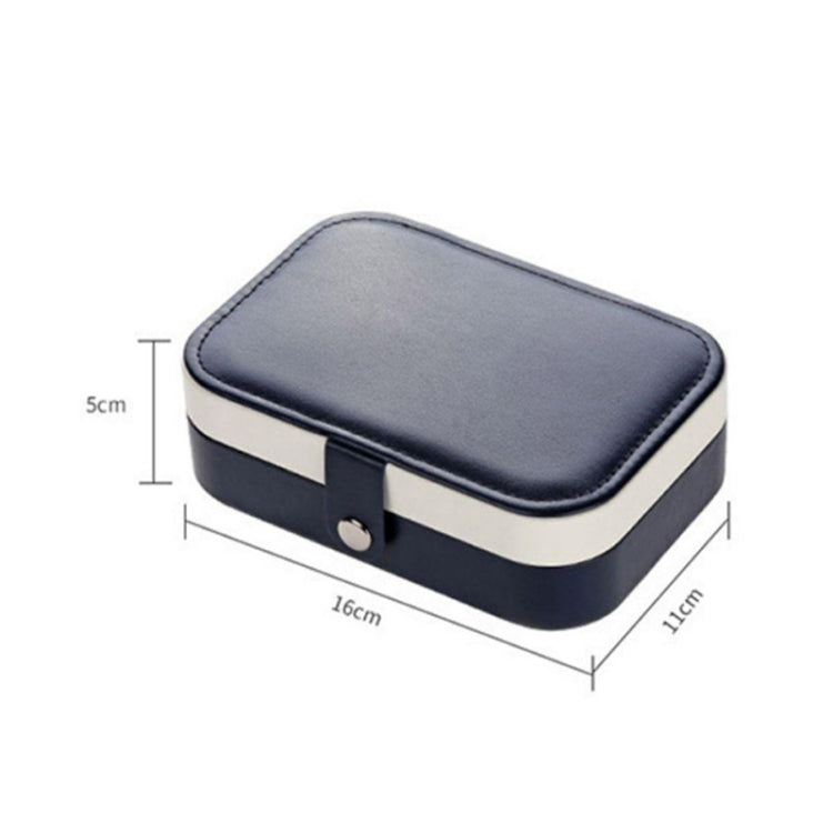 Portable jewelry storage box with rounded navy lid and snap clasp, cream sides