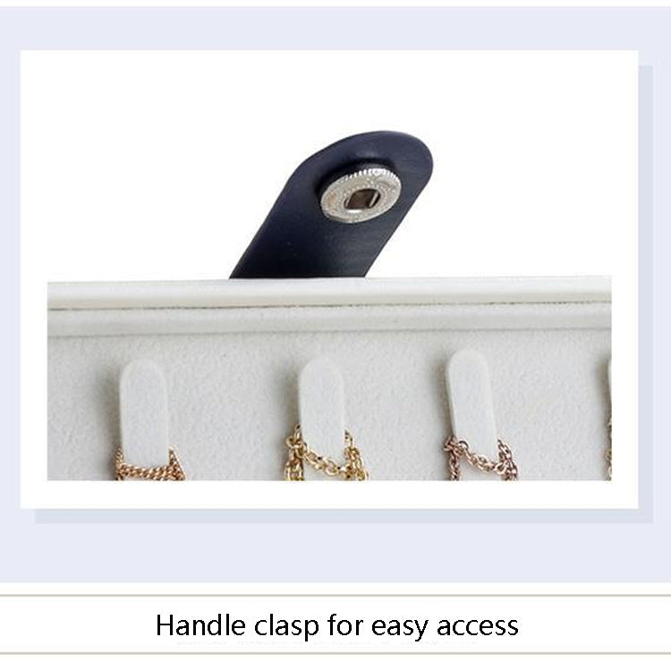 Jewelry box handle clasp with navy strap; flannel insert holding earrings