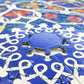 Close-up of a blue round jigsaw puzzle with interlocking piece edges