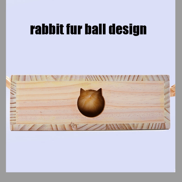Wooden cat puzzle board with a dark plush ball in the tunnel opening.