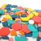 Close-up of colorful wooden jigsaw pieces in hexagon, circle, and curved shapes