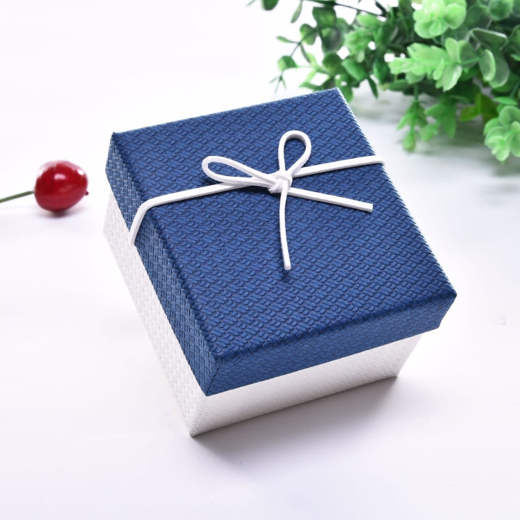 Small jewelry gift box with blue lid and gray base, tied with white ribbon bow.