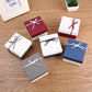 Square jewelry gift boxes with ribbon bow lids in maroon, blue, and grey