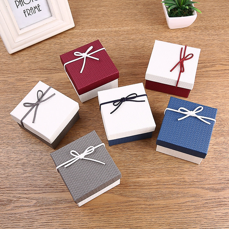 Square jewelry gift boxes with ribbon bow lids in maroon, blue, and grey