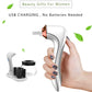 Hand holding white makeup brush cleaner and dryer unit with copper nozzle and black cup
