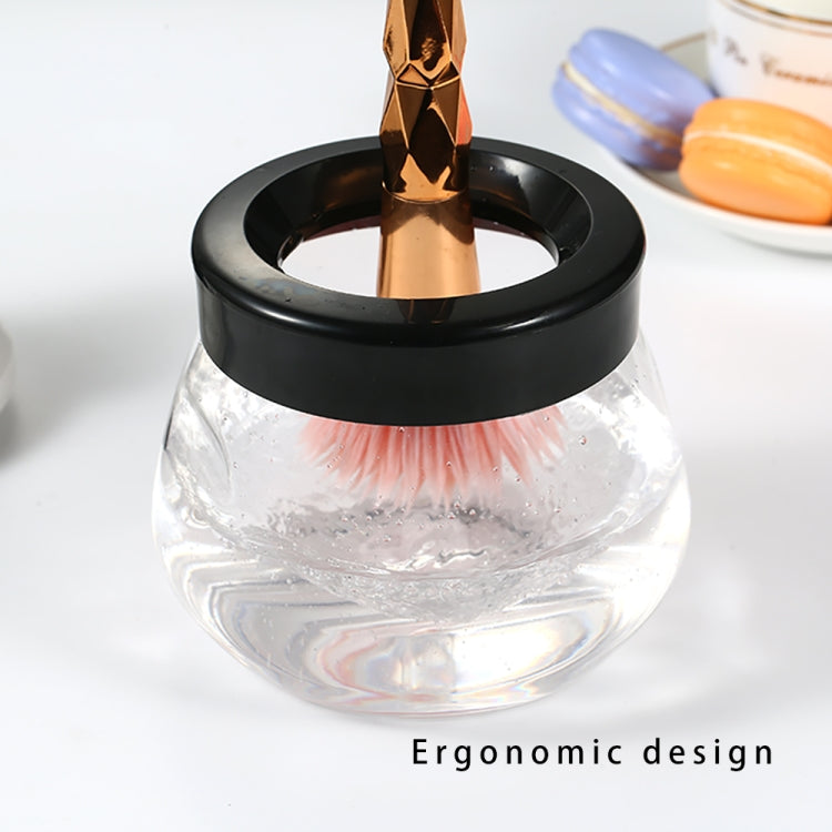 Clear drying bowl with black rim and gold rotating nozzle of makeup brush cleaner dryer