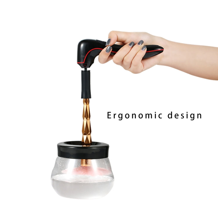 Makeup brush cleaner and dryer with black handle and copper nozzle positioned over clear bowl