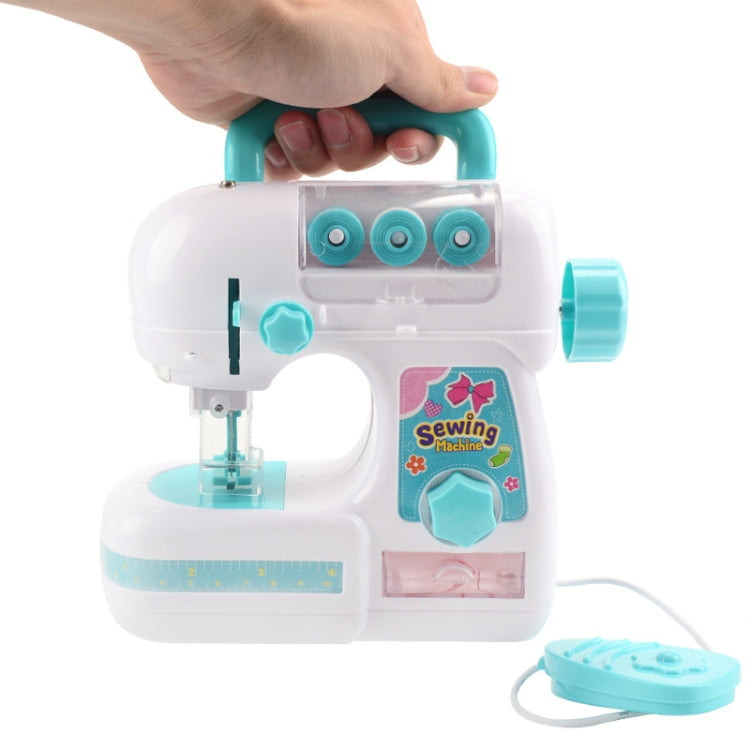 Toy electric sewing machine held by teal handle, white body with turquoise bobbins and cord
