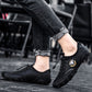 Black leather casual sneakers with strap closure and rugged rubber tread sole