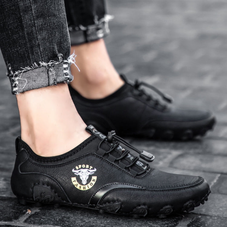 Black leather casual sneakers with adjustable strap and textured rubber tread sole