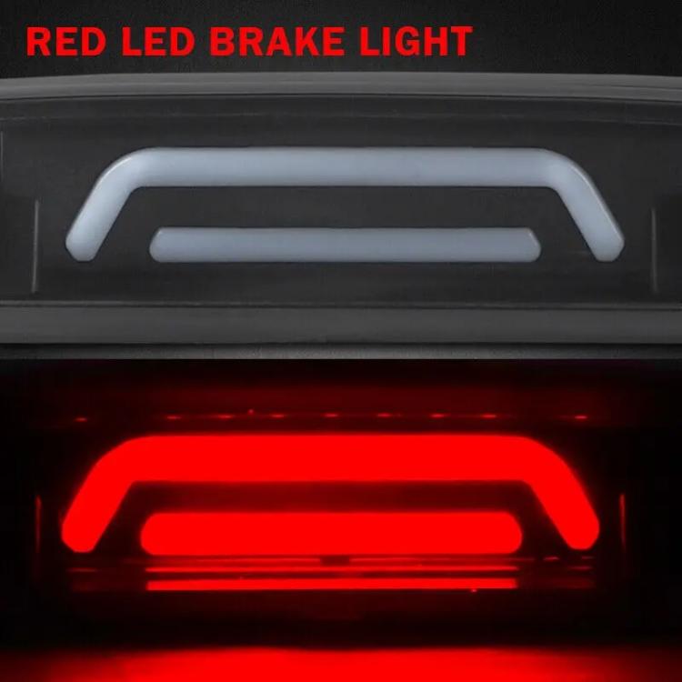 Close-up of red LED brake light glow in smoked-lens high-mounted housing