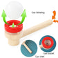 Wooden ball blower toy with red base, long handle, and white ball