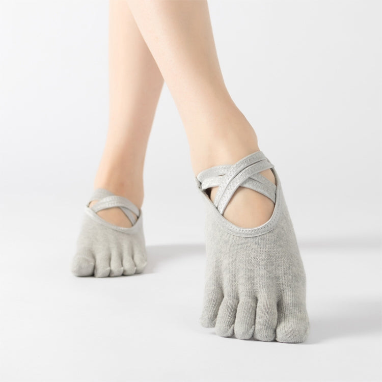 Light gray five-finger yoga socks with crisscross toe strap, full toe style