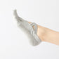 Light gray open-toe five-finger socks with cross strap