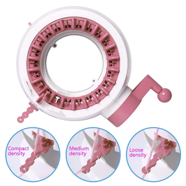 Top view of pink knitting loom toy machine with circular stitch ring and crank