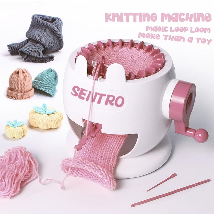 Pink and white knitting loom toy machine with knitted fabric and mini knit hats