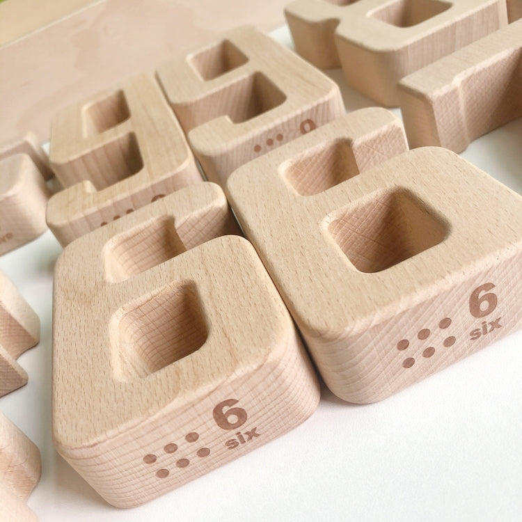 Close-up of wooden number blocks showing printed number and dot pattern on one block