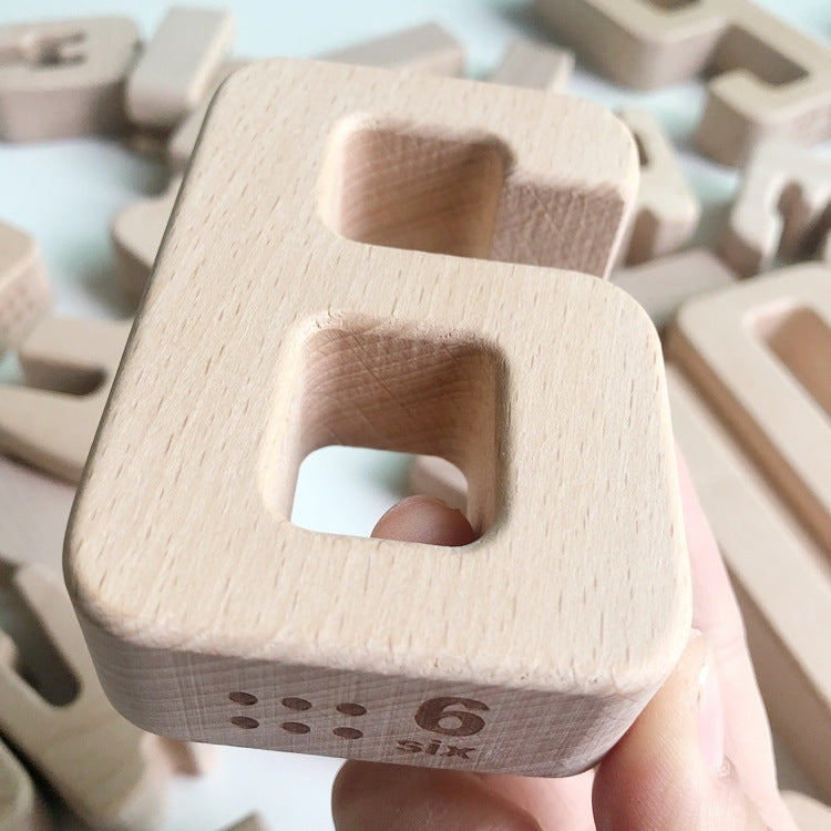 Close-up view of a wooden number block with large square cutout and printed dots