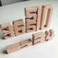Wooden number blocks arranged in a row, featuring large digit shapes