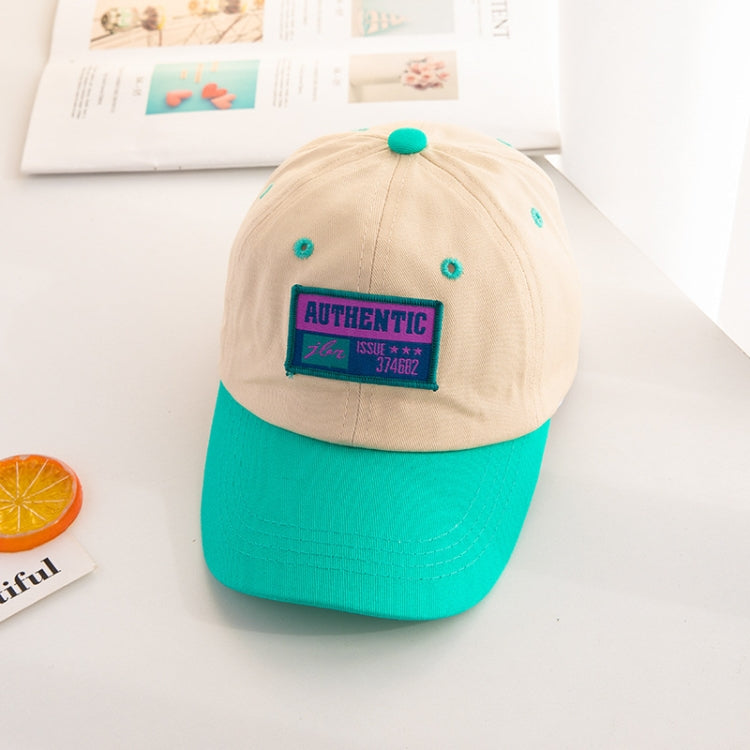 Kids baseball cap with beige crown, teal brim, and “AUTHENTIC” front patch