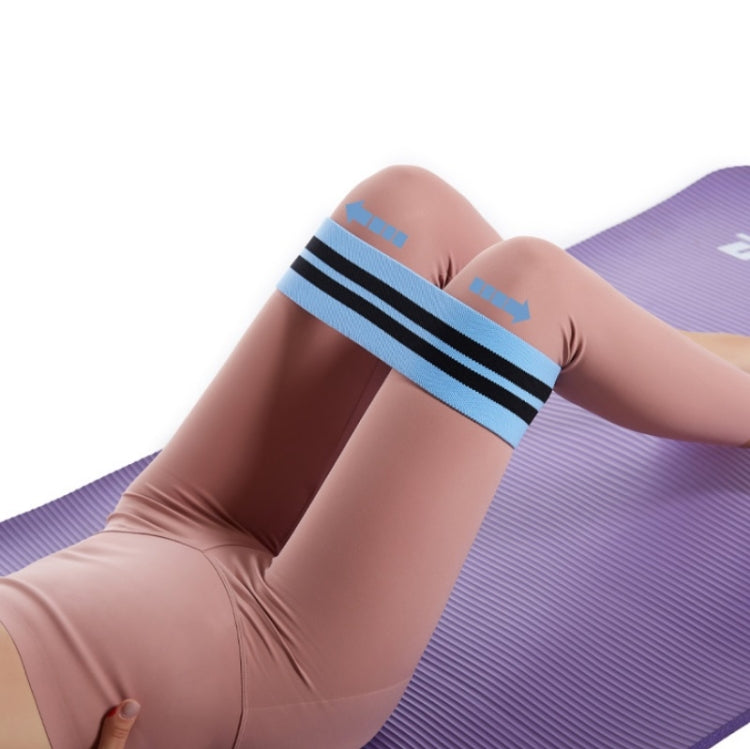 Blue resistance loop band with black stripes stretched around thighs