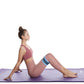 Blue resistance loop band with black stripes worn during lunge on a purple mat