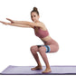 Blue resistance loop band with black stripes on thighs during squat exercise