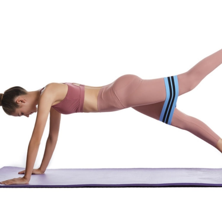 Blue resistance loop band with black stripes around thighs in plank position
