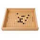 Wooden grid strategy game board with black and white round discs and star-point lines