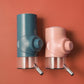 Teal and pink hanging pet waterer with metal nozzle and stainless drip tray