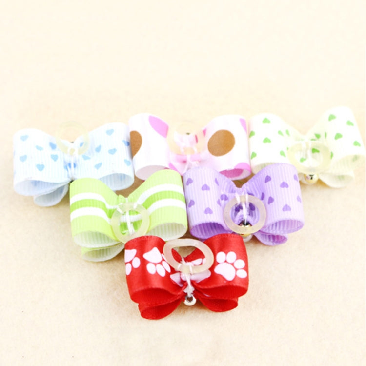 Close-up of colorful ribbon dog bow ties with pearl accents: light blue, pink, green, purple, and red