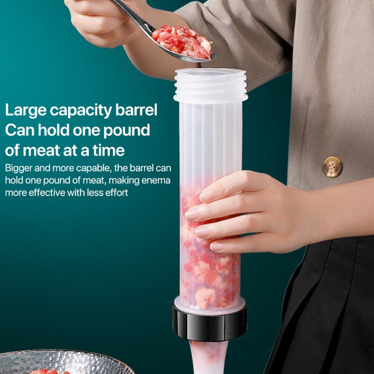 Sausage stuffer with tall barrel holding raw meat mixture, gripped by hands
