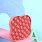 Pink silicone pop-it pressing board close-up with raised bubble pattern