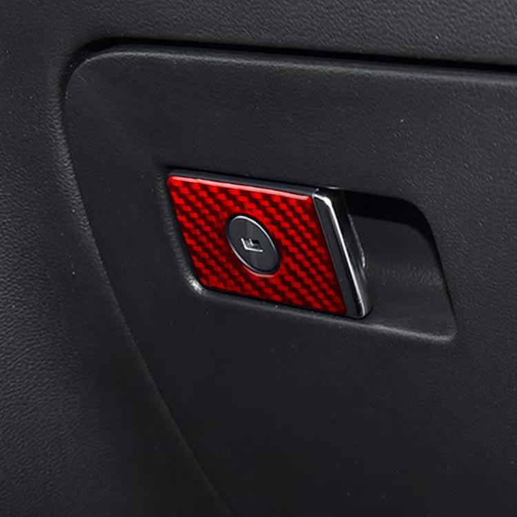 Red carbon-fiber glove box trim panel with small circular control cutout