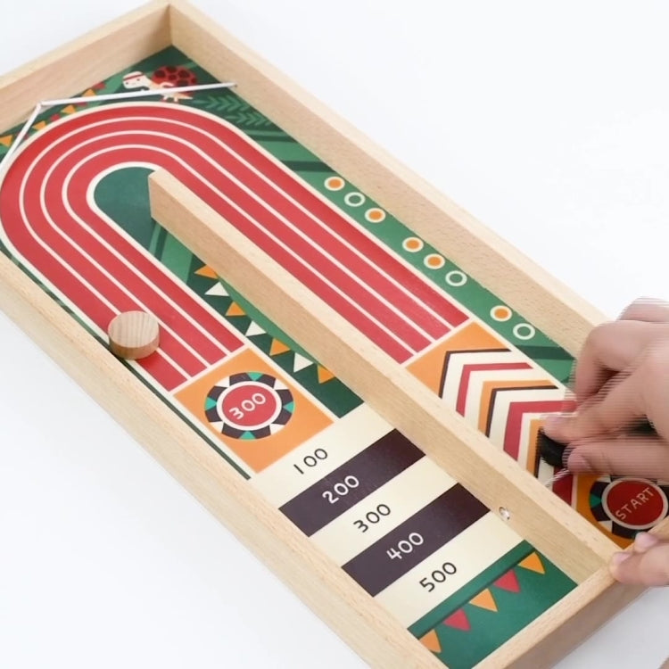Wooden catapult chessboard game in use with hand launching a puck on track