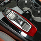 Red carbon-fiber gear shift panel trim surround around gear selector buttons