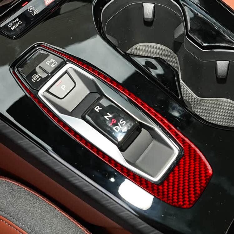 Red carbon-fiber gear shift panel trim surround around gear selector buttons