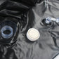 Inflatable punching bag accessories: black air valve parts and a white screw cap.
