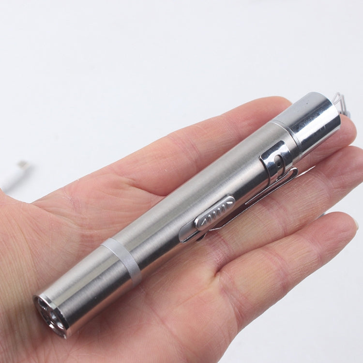 Silver USB laser flashlight stick held in hand, with side switch