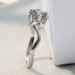 Side view of sterling silver ring with prong-set multicolor faceted gemstone on a curved band