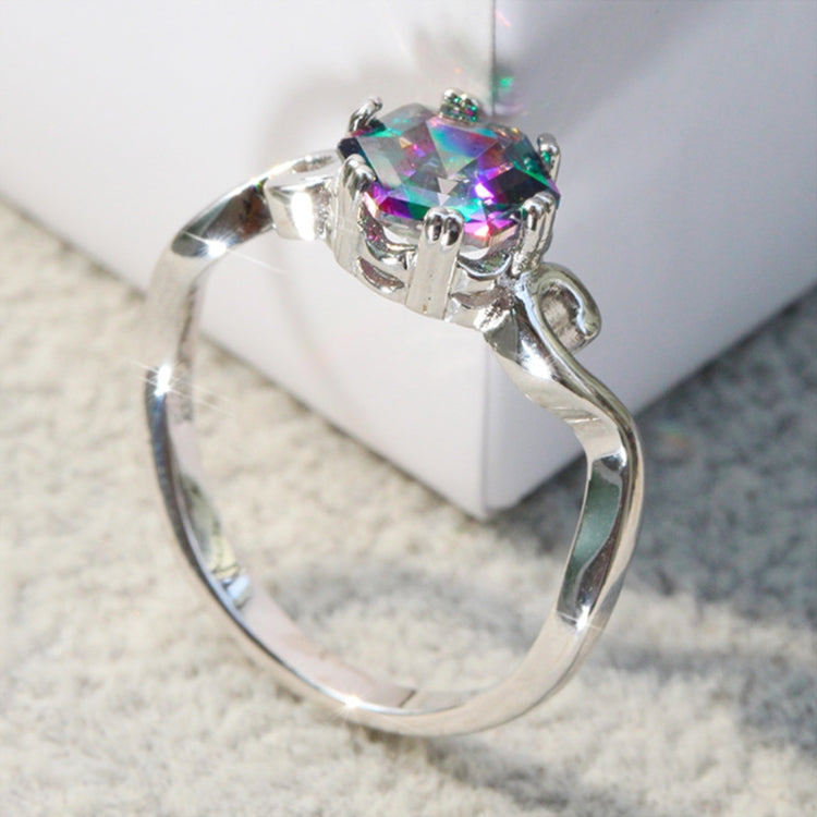 Close-up of sterling silver ring showing multicolor faceted gemstone and decorative setting prongs