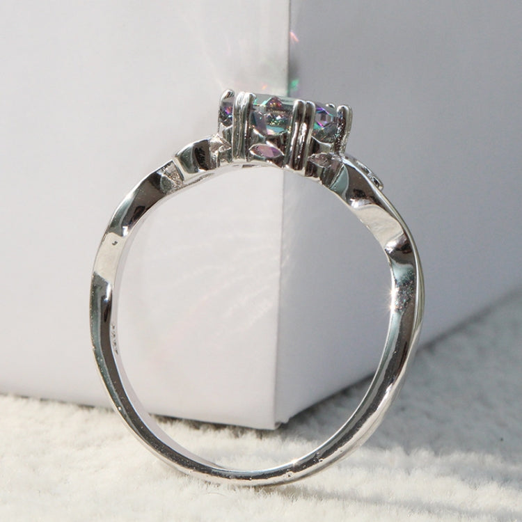 Top view of sterling silver ring band with prong-set multicolor faceted gemstone