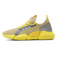 Beige knit running shoe with yellow sock collar, side shield, and cushioned sole