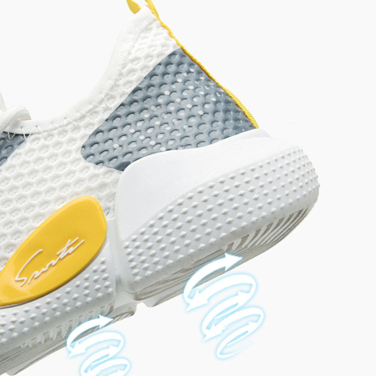 Close-up of beige and dark blue knit upper with thick white midsole and yellow logo tab